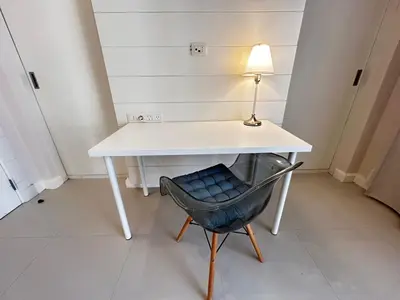 a desk and a chair with a lamp on it at luxury ancient stands resort one bedroom in Hurghada
