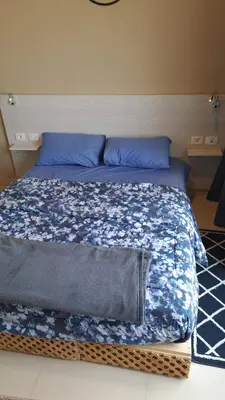 a bed with blue sheets and blue pillows at Makadi Heights in Hurghada