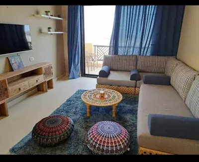 a living room with a couch and a table at Makadi Heights in Hurghada