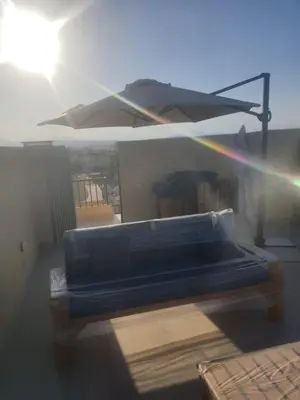 a bench sitting on a balcony with a rainbow at Makadi Heights in Hurghada