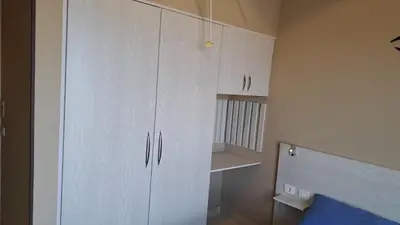 a kitchen with white cabinets in a room at Makadi Heights in Hurghada