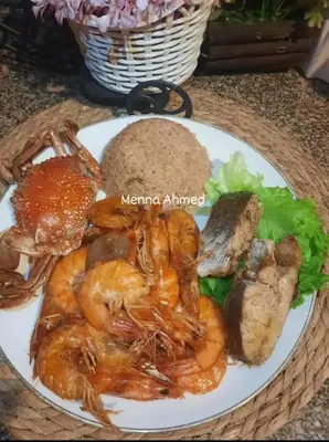 a plate of food with shrimp and bread on a table at City center NewAswan in Aswan