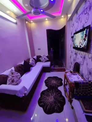 a living room with a couch and a tv at City center NewAswan in Aswan