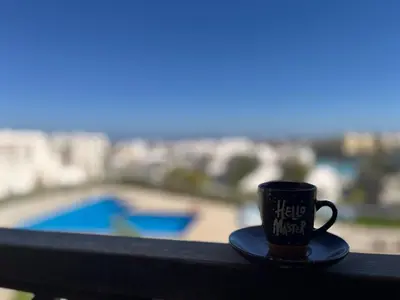 a coffee cup sitting on top of a balcony at Makadi heights - phase 2 in Hurghada