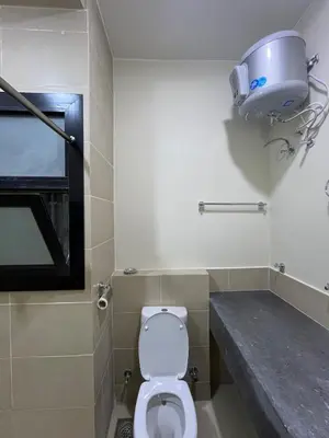 a bathroom with a toilet and a camera on the wall at Makadi heights - phase 2 in Hurghada