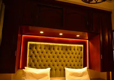 a headboard of a bed in a room at Aton Apartment, Luxor Resort, Minutes from City Center in Luxor