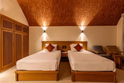 a bedroom with two beds and a wooden ceiling at UTOPIA Blue Resort in Quseir