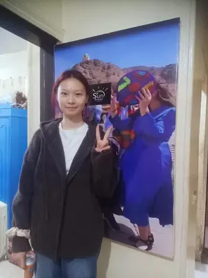 a young girl standing in front of a poster at Sun Aswan inn in Aswan