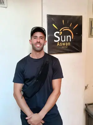 a man standing in front of a sun asian sign at Sun Aswan inn in Aswan