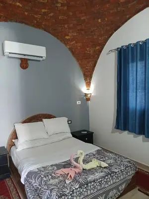 a bedroom with a bed with two snakes on it at Nile Rose Hause in Al Karnak