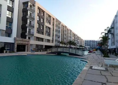a large pool of water in front of a building at Fanadir Bay Resort, rental chalet apartment in Hurghadana in Hurghada