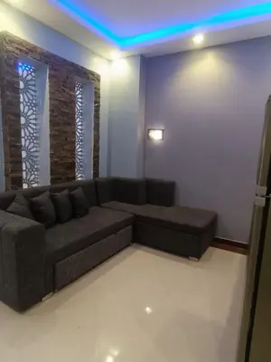 a living room with a couch and a blue light at Elite apartment private beach Holiday Chalet Free WIFI in Hurghada