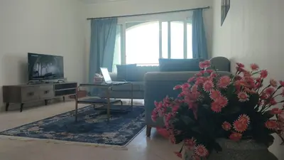 a living room with a couch and a table at comfort marina 5 apartment,s in Hurghada