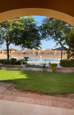 a view of a swimming pool from an archway at Apartment in the view 207 hill view in Hurghada