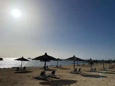 a group of chairs and umbrellas on a beach at One bedroom in Island View in Hurghada