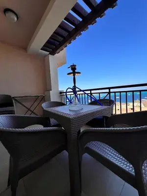 a table and chairs on a balcony with a view of the ocean at One bedroom in Island View in Hurghada