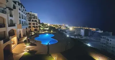 a view of a swimming pool at night at One bedroom in Island View in Hurghada