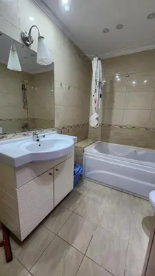 a bathroom with a tub and a sink and a bath tub at Studio for rent in the view 114 in Hurghada