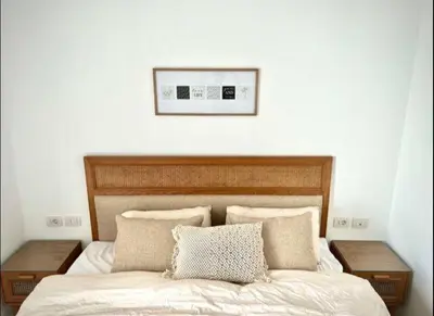 a bedroom with a bed with two tables and a picture on the wall at Luxury One bedroom in gouna in Hurghada