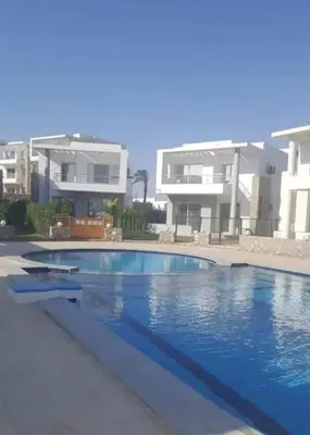 a swimming pool in front of a house at Sky star 130 in Hurghada