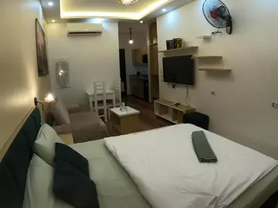 a bedroom with a white bed and a living room at Dive Hostel Hurghada Pool in Hurghada