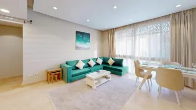 a living room with a green couch and a table at 2bedroom in mangrove in gouna in Hurghada