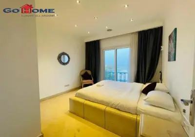 a bedroom with a large bed with a large window at Pretty 4Bedrooms Penthouse MB7 at New Abu Tig Marina in Hurghada