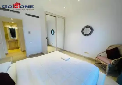 a room with a large bed and a chair in it at Pretty 4Bedrooms Penthouse MB7 at New Abu Tig Marina in Hurghada