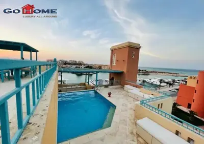 a view of the pool from the balcony of a resort at Pretty 4Bedrooms Penthouse MB7 at New Abu Tig Marina in Hurghada