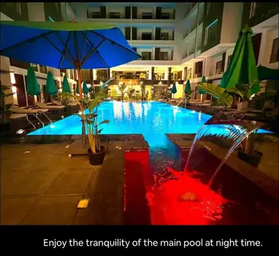 a swimming pool with an umbrella in a hotel at Studio Imperial resort pool view in Hurghada