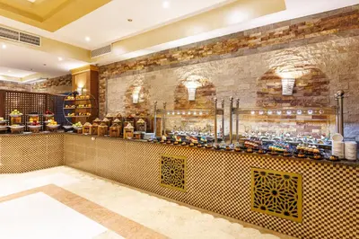 a bar in a restaurant with a brick wall at Sunrise Solara Aqua park Resort in Banī Ghālib