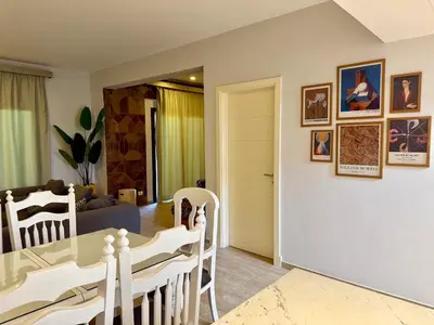 a dining room and living room with a table and chairs at Picturesque 3BR Villa- Free Lagoon Access ElGouna in Hurghada
