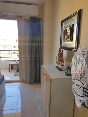 a living room with a table and a window at Tiba golden resort in Hurghada
