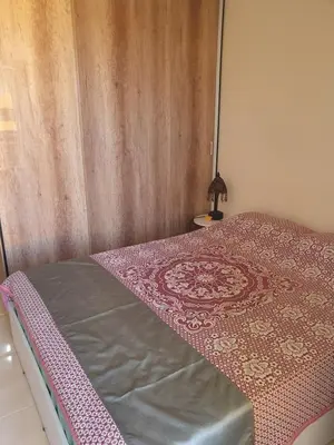a bedroom with a bed with a wooden wall at Tiba golden resort in Hurghada