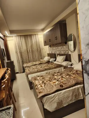 a hotel room with two beds and a mirror at Cecilia Village in Hurghada