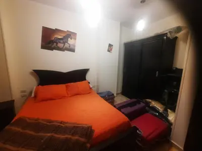 a bedroom with a bed with an orange comforter at Sea view holidays in Hurghada