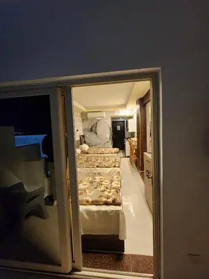 a view of a bedroom with three beds at Cecilia Village in Hurghada