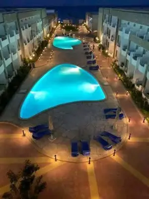 a large blue pool in the middle of a building at Cecilia Village in Hurghada