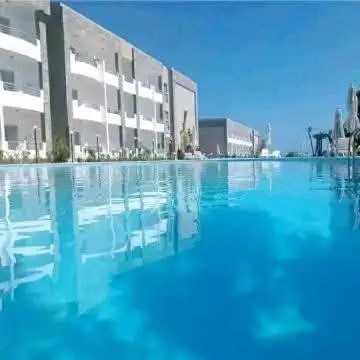 a large pool of water in front of a building at Cecilia Village in Hurghada