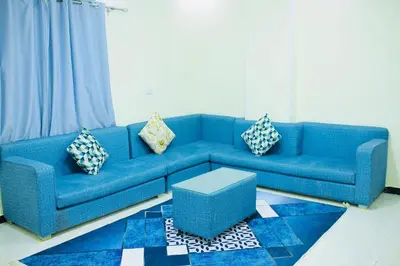 a blue couch in a living room with pillows at رويال بالاس in Hurghada
