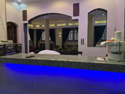a bathroom with a blue counter with two mirrors at Family House in Luxor