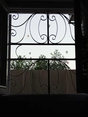 an open window with a view of a tree at White Rose House in Luxor