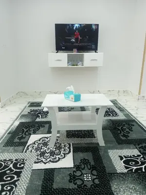 a white coffee table in a living room with a tv at White Rose House in Luxor