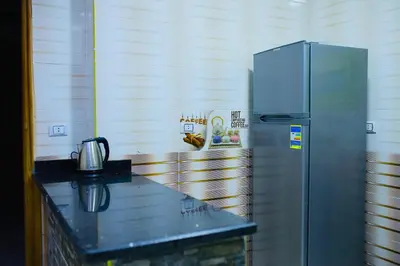 a kitchen with a stainless steel refrigerator on a counter at Royal palace in Hurghada