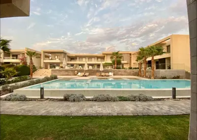 a large swimming pool in front of a building at G Cribs Pool Front Studio in Hurghada