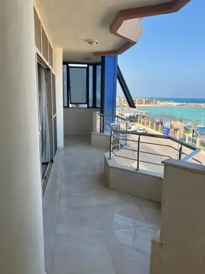 a balcony of a building with a view of the ocean at Apartment with sea view in Hurghada