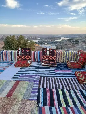 a group of pillows sitting on top of a table at Mashamman nuban house in Aswan