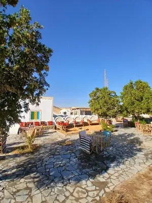 a group of tables and chairs in a courtyard at Mashamman nuban house in Aswan