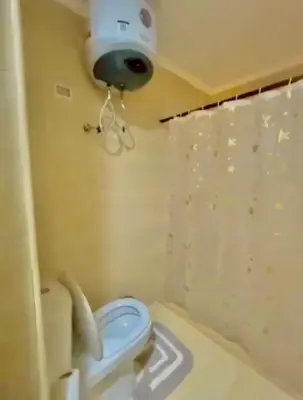 a bathroom with a toilet with a camera on the wall at Hurghada Escape Pool and Sea View in Hurghada