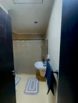a bathroom with a sink and a white toilet at Hurghada Escape Pool and Sea View in Hurghada